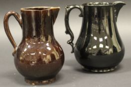 An 18th Century Jackfield black glazed pottery baluster shaped jug with scroll work handle,