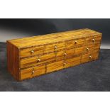 An early 19th Century mahogany dwarf bank of ten drawers with barber pole strung and cross banded
