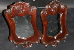 A pair of shield shaped wall mirrors with mahogany frame in the Rococco taste,