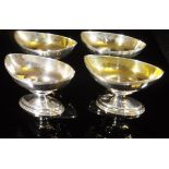 A set of four (composite) silver boat-shaped salts, each with gilded interior (by Peter,