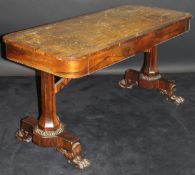 A William IV rosewood library table with tooled and gilded leather insert top above two freize