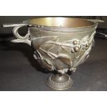 A Victorian bronze trophy cup with heavy relief work, ivy and berry decoration,