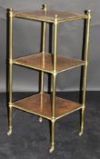 A 19th Century mahogany and lacquered brass three tier étagère with brass caps and brass castors,