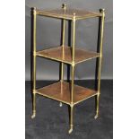 A 19th Century mahogany and lacquered brass three tier étagère with brass caps and brass castors,