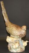A 19th Century Meissen figure group of a hen pheasant and chicks on a rocky base,