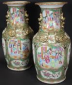 A pair of 19th Century Chinese famille-rose polychrome decorated vases with flared rims,