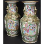 A pair of 19th Century Chinese famille-rose polychrome decorated vases with flared rims,