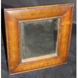 A oyster walnut cushion framed rectangular wall mirror in the early 18th Century manner with plain