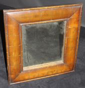 A oyster walnut cushion framed rectangular wall mirror in the early 18th Century manner with plain