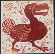 William de Morgan glazed pottery tile, decorated in ruby lustre with a dodo,