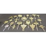 A collection of brass handled corkscrews including various decorated with buildings,