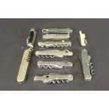 A collection of various pocket knives with corkscrews including one inscribed "Aylmer 19th August