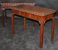 A pair of George III mahogany card tables in the manner of Thomas Chippendale,