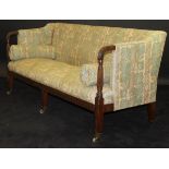 A late George III mahogany framed three seat settee with cream ground foliate patterned upholstery,