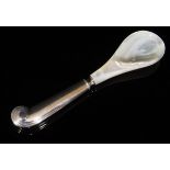 A modern silver handled caviar spoon with mother of pearl bowl and pistol grip handle (by James