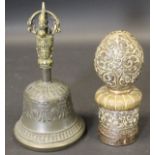 A Tibetan bronze and brass vajra handled bell and a white metal brass and copper mounted seal with