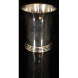 A modern silver beaker of plain form with flared rim and banded decoration to base,