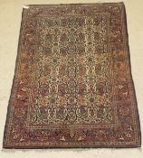 A Kashan rug, the central panel set with an all over floral and paisley design on a cream ground,