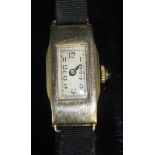 An early 20th Century ladies 9 carat gold cased wristwatch, the silvered dial with Arabic numerals,