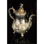 A Victorian silver coffee pot with all-over scrolling foliate decoration,