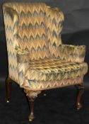 An early 18th Century upholstered wing back,