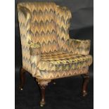 An early 18th Century upholstered wing back,