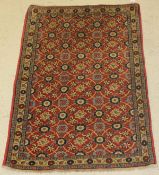 A Caucasian rug, the central panel set with all over floral sprays,