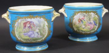 A pair of 18th Century Sèvres "Bleu Celeste" ice pails decorated with a panel of lovers in a garden