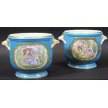 A pair of 18th Century Sèvres "Bleu Celeste" ice pails decorated with a panel of lovers in a garden