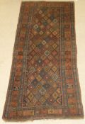 A Caucasian runner, the central panel set with repeating diamond medallions on a blue ground,