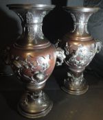 A pair of 19th Century Japanese bronze vases of baluster form with flared rims,