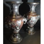 A pair of 19th Century Japanese bronze vases of baluster form with flared rims,