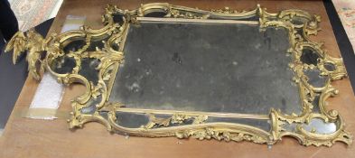A George III gilt wood and gesso framed wall mirror in the Rococo taste,