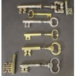 Six various brass and steel corkscrews in the form of large keys,