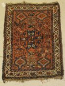 A Shiraz rug, the central panel set with stylised floral decorated medallion,