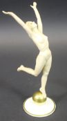 A Lorenz Hutschenreuther Art Deco figure of a nude dancing lady upon a gold ball designed by Carl