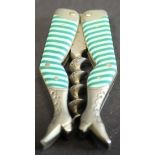 A novelty folding pocket corkscrew in the form of a pair of ladies legs with green striped