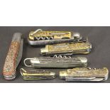 A collection of various antler cased pocket knives,