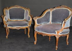 A pair of 19th Century French walnut salon chairs with carved foliate and shell show frames with