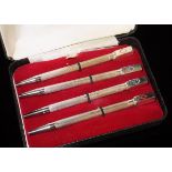 A cased set of four silver Bridge pencils, each finial with a different suit (Birmingham, 1989),