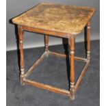 An early 19th Century oak occasional table, the square, burr brown oak top with rounded corners,
