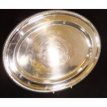 A George V silver tray of oval form with gadrooned edge and engraved initials "PN" (by James Dixon