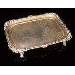 An Edwardian silver card tray of rectangular form with gadrooned and shell decorated rim,