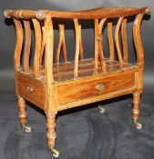 An early 19th Century mahogany and inlaid canterbury with ringed and turned supports and reeded