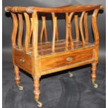 An early 19th Century mahogany and inlaid canterbury with ringed and turned supports and reeded