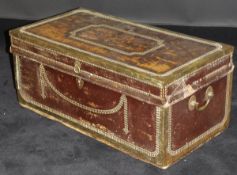 A late 19th Century teak brass bound and leather covered trunk in the colonial manner, 77.