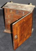 An 18th Century walnut and boxwood strung spice cupboard,