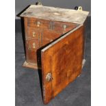 An 18th Century walnut and boxwood strung spice cupboard,
