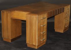 A 1920's French Art Deco walnut veneered partners desk by Dominique of Paris,