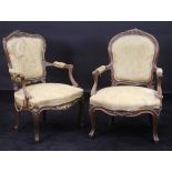 A pair of 19th Century Louis XV style walnut salon elbow chairs with carved and guilded show frames